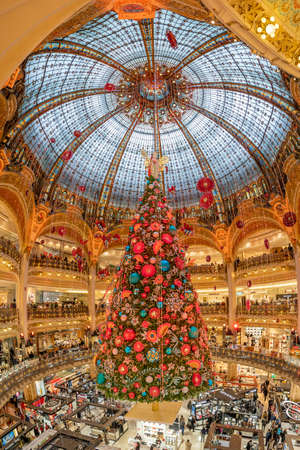 Paris, France - December 15: Massive Christmas tree decoration with flowers inside Galerie Layfayette shopping mallのeditorial素材