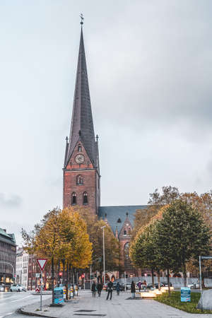 Hamburg, Germany - November 9, 2019: People walk on the street towards thurch of Petrikirche after sunsetのeditorial素材