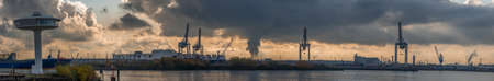 Panoramic view of Hamburg Harbor from Hansestadt with dramatic stormy clouds and sunlightの写真素材