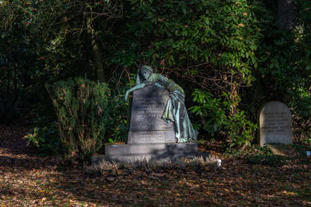 Hamburg, Germany - November 9, 2019: Tomb stone with sculpture in Ohlsdorf Cemetery in the morning in Hamburg city, Germanyのeditorial素材