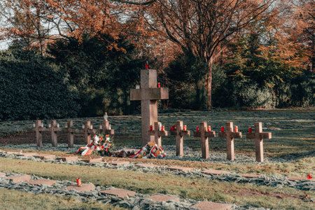 Hamburg, Germany - November 9, 2019: Tomb stone cross in graveyeard in Ohlsdorf Cemetery during fall in Hamburg city, Germanyのeditorial素材