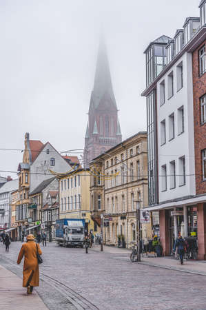 Schwerin, Germany - Novermber 11, 2019: Street view of clock tower of Schwerin Cathedral with fogのeditorial素材