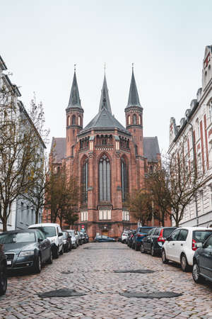 Backside facade of Paulskirche church with pointy towers in Schwerin near Hamburgの写真素材