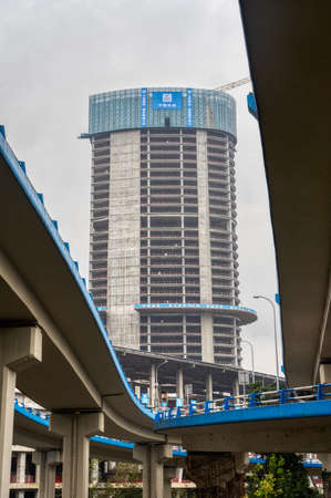 Chongqing, China - Dec 20, 2019: Skyscraper in construction view from under flyoverのeditorial素材