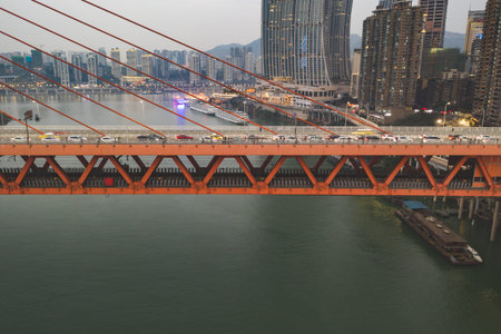 Chongqing, China - Dec 22, 2019: Qian si men suspension bridge over Jialing Rivier in cloudy weatherのeditorial素材