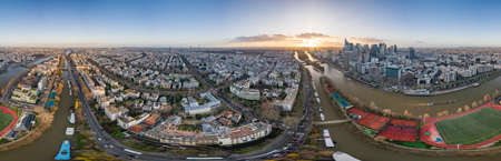 360 aerial drone photo of Levallois and La Defense skyscrapers by la Seine during sunset hourのeditorial素材