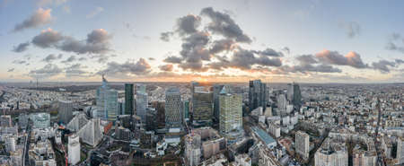 Aerial panoramic drone shot of La Defense skycraper with park diderot in Paris with clouds and sunsetのeditorial素材