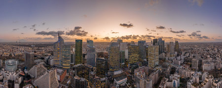 Aerial panoramic drone shot of La Defense skycraper with park diderot in Paris with clouds and...