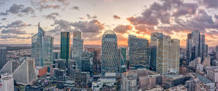 Aerial panoramic drone shot of La Defense skycraper with park diderot in Paris with clouds before sunsetの写真素材