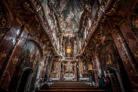 Tourists admire Interior of Asamkirche baroque style church with altar and ceilingのeditorial素材