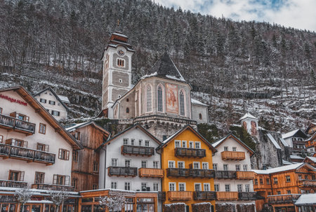 Feb 6, 2020 - Hallstatt, Austria: evangelical church covered in snow during winter in town center