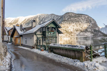 Village street by lake Hallstatt covered in snow during winter in upper Austriaのeditorial素材