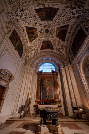 Stove and paintings altar with view of ceiling stuccowork in aisle inside Salzburg Cathedralのeditorial素材
