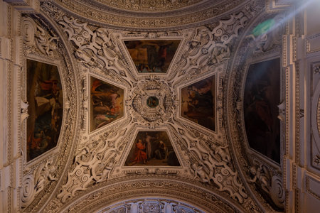 Ceiling mural with paintings inside Salzburg Cathedral with dim lightのeditorial素材