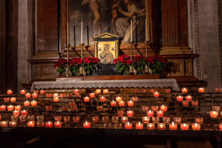 Candles before Virgin Mary painting inside Salzburg Cathedral with low lightのeditorial素材