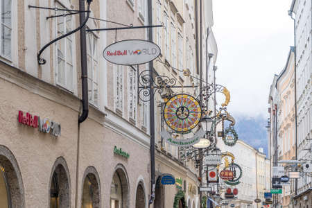 People wander on the street of Getreidegasse during cloudy dayのeditorial素材