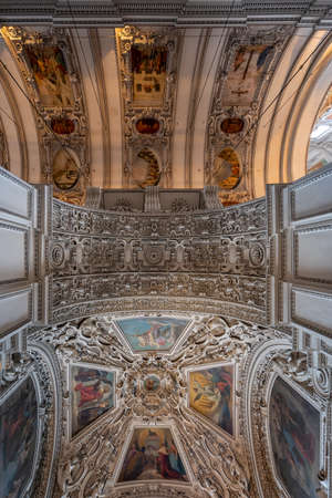 Upward view of marble arch between nave and aisle with exquisite ornamentation inside Salzburg Cathedralのeditorial素材