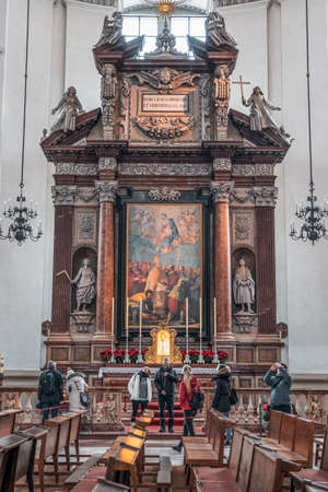 Tourists admire the dome in front of altar inside Salzburg Cathedralのeditorial素材