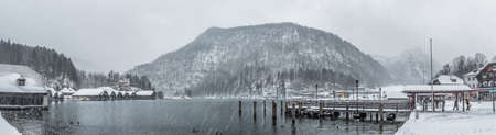 Panorama view of lake Konigssee pier during heavy snow in Germany in winter timeの写真素材