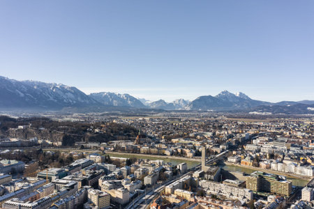 Aerial drone view of Salzburg snowy north town with view of Unesberg mountain in winter morning timeの写真素材