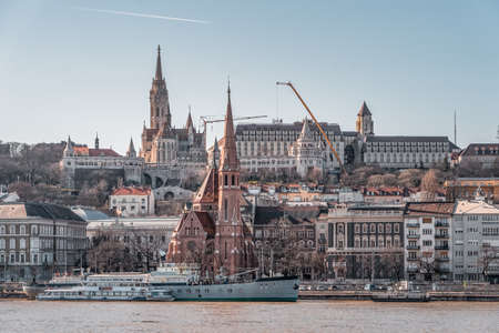 Danube river view of Pest side with Fisherman's bastion, matthias church, and szilagyi dezso square reformed church in winter timeの写真素材