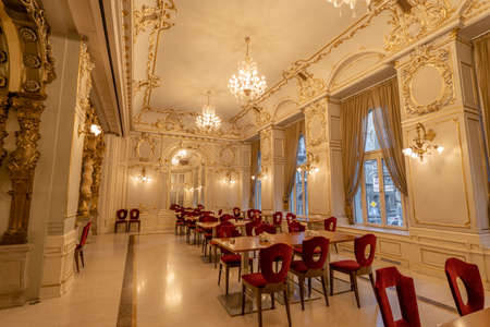 Budapest, Hungary - Feb 09, 2020: Golden dining hall in New York Cafe with floral ceiling. High quality photoのeditorial素材