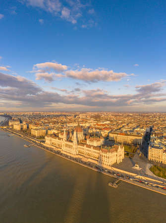Aerial drone view of Hungarian Parliament by Danube river in Budapest sunset hour in winterの写真素材