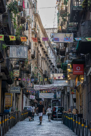 Naples, Italy - August 15, 2019: City street with residents balcony in historic city center