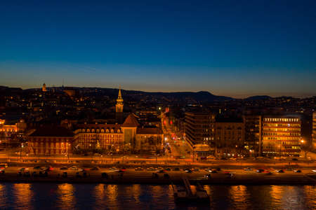 Aerial drone shot of St. Francis parish church by Danube in Budapest twilight in winterの写真素材