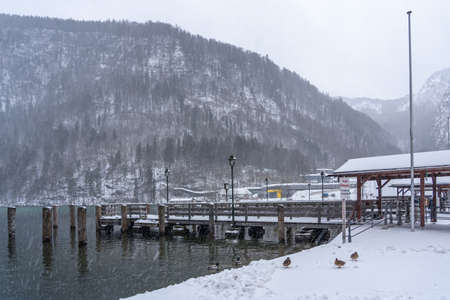 Dock by lake Konigssee during heavy snow in Germany in winterの写真素材