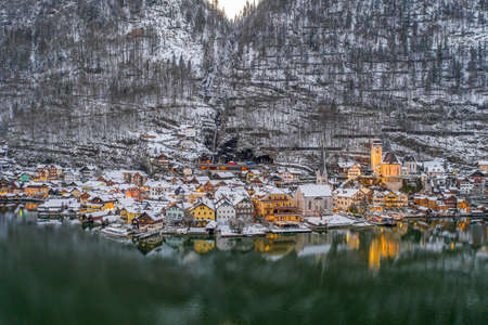 Aerial drone shot of beautiful snowy Hallstatt village by lake iの写真素材