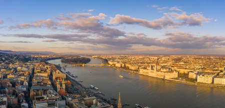 Panoramic aerial drone sunset view of Hungarian Parliament by Danube river with dramatic clouds in Budapestの写真素材