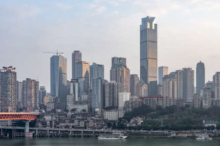 Chongqing, China - Dec 22, 2019: Qian si men suspension bridge over Jialing Rivier in cloudy weatherのeditorial素材