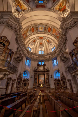 Ultrawide view of dome and ceiling with low light inside Salzburg Cathedralのeditorial素材