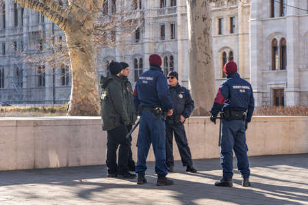 Hungarian Policemen discuss near Kossuth Square in winter morningのeditorial素材