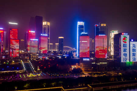Chongqing, China - Dec 22, 2019: Aerial view of builings with neon lights in the evening by Jialing riverのeditorial素材