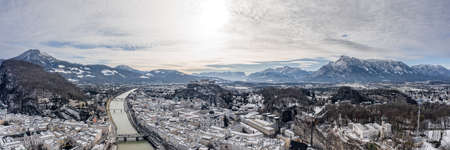 Panoramic aerial drone shot view of snoy Salzburg in winter morningの写真素材