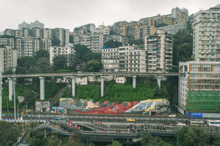 Chongqing, China - Dec 22, 2019: Aerial drone view of light rail to Liziba station residential buildings on the hillのeditorial素材