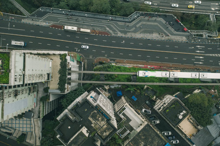 Aerial drone overhead view of Chongqing light rail carriage to Liziba transit along residential buildings on the streetの写真素材