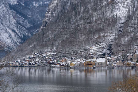 View of snow covered Hallstatt village from train station in winter in Austriaの写真素材