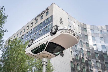 Paris, France - Jun 13, 2020: Flipped car as art display in front of Spaces building in la defenseのeditorial素材