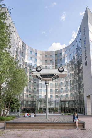 Paris, France - Jun 13, 2020: Flipped car as art display in front of Spaces building in la defenseのeditorial素材