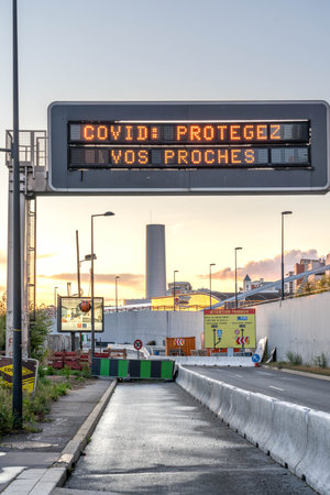 Paris, France - Jun 18, 2020: LED Traffic displayboard show info of COVID-19 pandemic near La...