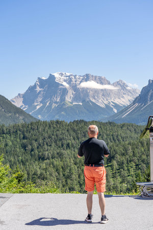 Fernpass, Austria - Aug 6, 2020: Tourist take photo of west side of Zugspitze in snow in Fernpass Austriaのeditorial素材
