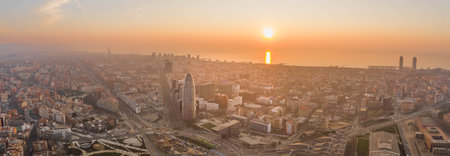 Pano aerial drone shot of Barcelona city with sunrise over horizonの写真素材