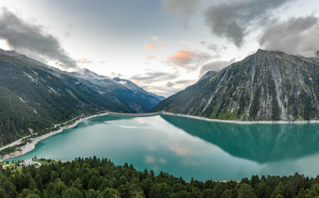 Aerial drone shot of Schlegeisspeicher resevoir with galcier view at duskの写真素材