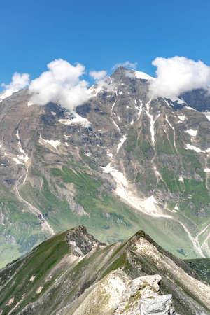 Clouds over summit at Grossglockner mountain range view from Taxenbacher Fusch high alpine road in Austriaの写真素材