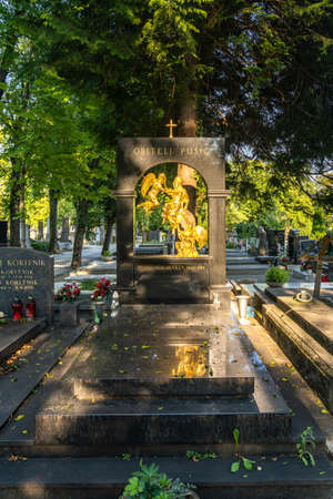 Zagreb, Croatia - Aug 9, 2020: Marble grave with golden statue in sunset hour in Mirogoj Cemeteryのeditorial素材