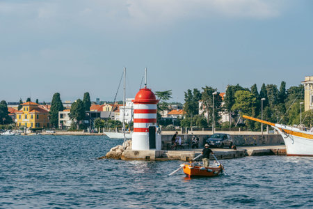 Zadar, Croatia - Aug 13, 2020: Lighthouse in city harbour in afternoonのeditorial素材