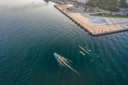 Aerial drone shot of boat kayak near nomuent to the sun at Zadar peninsula in sunrise in Croatiaの写真素材